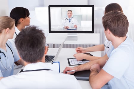 Doctors sat around a table being trained by an avatar